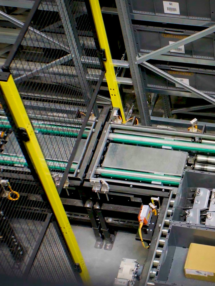 Conveyor system with safety fencing, marking a restricted or hazardous area in a warehouse